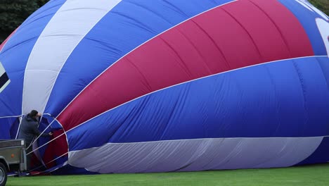 Close-up-shot-of-a-man-setting-up-his-hot-air-balloon-at-the-Strathaven-Balloon-Festival