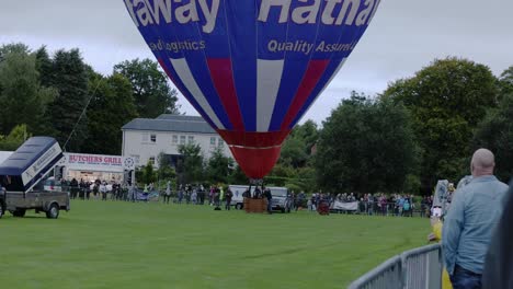 Hand-held-shot-of-crowds-watching-hot-air-balloons-at-Strathaven-Balloon-Festival