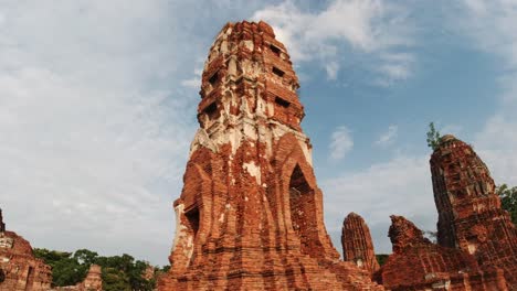 Tilt-Up-Shot-of-Ayutthaya's-Thai-Historical-Temples-with-Tourists-in-the-Background