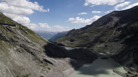 Alpine-lake-water-from-the-fastest-melting-Pasterze-glacier-at-the-foot-of-the-Grossglockner-Mountain-in-the-Austrian-Alps,-Drone-shot