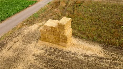 Aerial-View-of-Square-Hay-Bales-Stacked-In-The-Fields