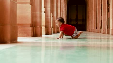 cute-toddler-crawling-at-gallery-white-marble-floor-at-day