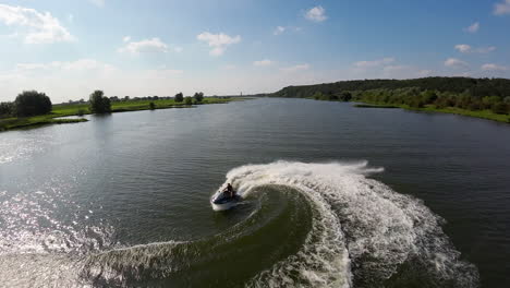 Action-sport,-man-rides-jet-ski-on-the-river-Rhine-on-a-sunny-summer-day,-fpv
