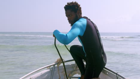 Marine-Conservationist-Pulling-Boat-Anchor-Before-Sailing-Out-To-The-Sea-For-Scuba-Dive-In-Mombasa-Kenya,-Africa