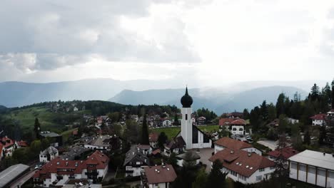 Establishing-aerial-view-of-Oberbozen,-Italy-on-a-cloudy-day