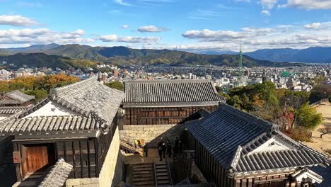 View-from-the-castle-towers-ont-the-yard-an-roofs-of-Matsuyama-Castle,-Shikoku,-Ehime,-Japan