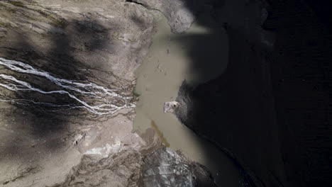 Drone-shot-revealing-alpine-lake-from-melting-glacier-ice-at-the-foot-of-the-Grossglockner-Mountain-in-the-Austrian-Alps,-Aerial-view