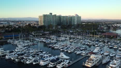 Drone-flying-over-expensive-yachts-and-boats-docked-at-Marina-Del-Rey