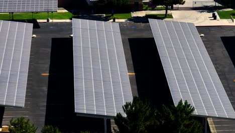 Solar-panels-in-a-parking-lot-provide-shade-and-renewable-energy---aerial-flyover