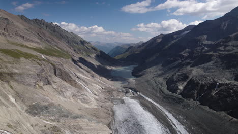 Alpine-Pasterze-glacier-lake-at-the-foot-of-the-Grossglockner-Mountain-in-the-Austrian-Alps,-Slow-Motion,-Drone-shot