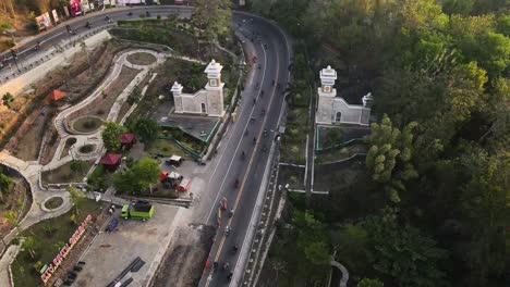 aerial-view,-heavy-traffic-flowing-smoothly-on-the-incline-route,-the-welcome-border-of-Gunung-Kidul,-Yogyakarta