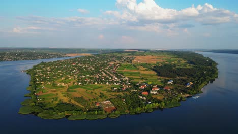Drone's-Lens-Capturing-the-Picturesque-Beauty-of-Nature's-Embrace,-over-Majestic-Dniester-River-and-Molovata-Village,-Birds-eye-View