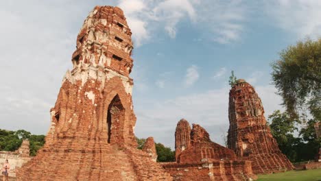 Tilt-Up-Shot-Of-Historical-Buddhist-Temples-in-Ayutthaya,-Thailand