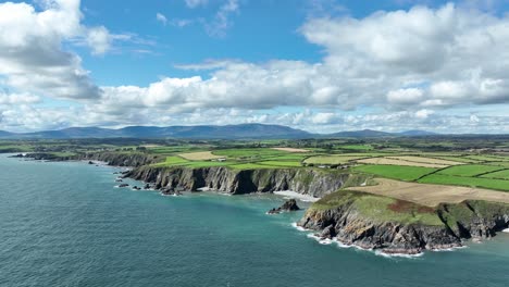 Drone-flying-to-the-coast-of-Ireland-at-Copper-Coast-Waterford-on-a-bright-summer-day