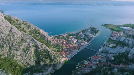 Magical-European-city-Omis,-Croatia,-scenic-aerial-over-town-skyline-and-nature