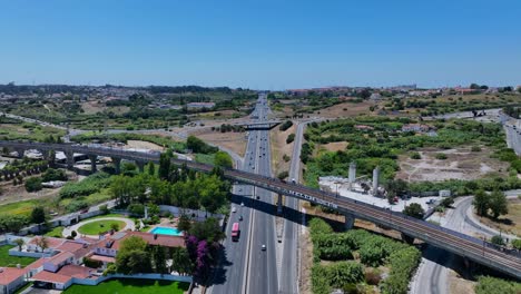 Drone-shot-of-a-traintrack-bridge-that-goes-over-a-highway