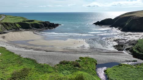 Drone-Coast-Of-Ireland-sheltered-Kilmurrin-Cove-on-The-Copper-Coast-Waterford-on-a-calm-summer-day
