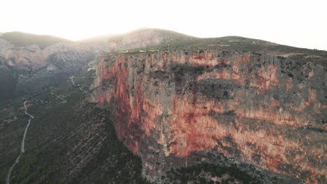 Epic-cliff-face-of-leonidio,-intimidating-challenge-for-climbers-traveling-to-greece,-aerial-overview