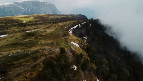 Morning-Drone-Shot-of-Hiking-Cliff-with-White-Snow-and-a-lot-of-misty-fog---Cinematic-Drone-Shot