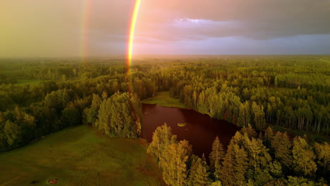 A-Beautiful-Double-Rainbow-Reflecting-Colorful-Light-Over-a-Scenic-Lake-and-Forest-in-Latvia