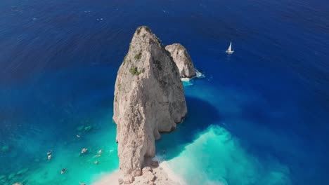 Drone-Shot-of-Myzithres-Rocks,-White-Beach-and-Blue-Sea-Under-Cliffs-of-Zakynthos-Island,-Greece