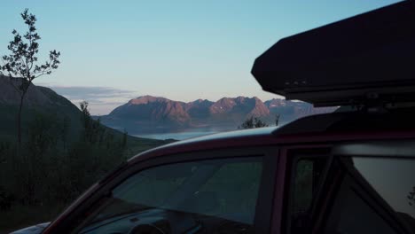 Vehicle-With-Roof-Top-Tent-In-A-Rocky-Mountain-Lake-Background