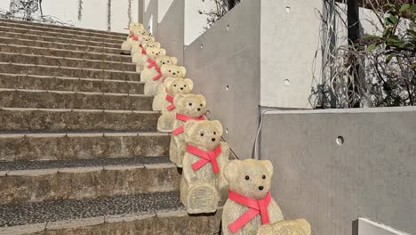 rows-of-teddy-bears-sitting-on-stone-stairs