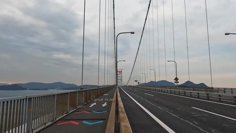Bike-lane-and-highway-on-the-cycle-lane-at-Kurushima-Kaikyo-Bridge,-Ehime,-Japan