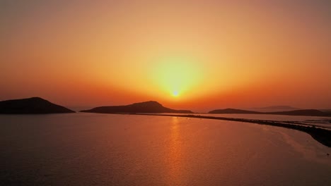 Peaceful-sun-set-spreading-golden-yellow-rays-to-orange-red-gradient-above-pylos-greece-ocean