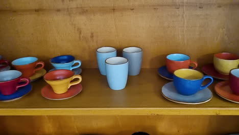 Handmade-ceramic-tableware-with-a-set-of-colorful-clay-cups-and-plates