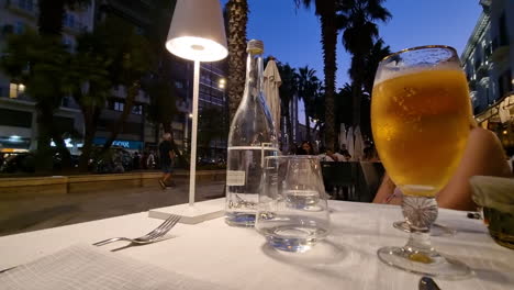 Table-in-restaurant-at-the-Palm-Trees-Alley-at-Corso-Vittorio-Emanuele-park-in-the-city-center-of-Bari-Puglia-Italy