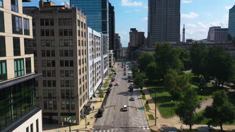 Aerial-view-flying-low-over-streets,-in-middle-of-skyscrapers-of-downtown-Indianapolis,-USA