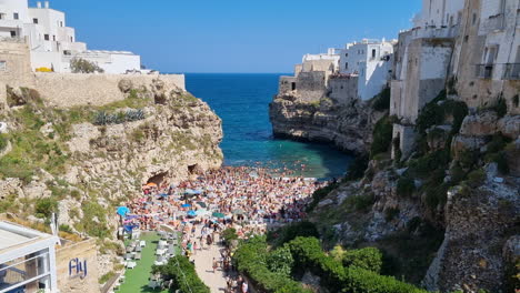 Panorama-view-of-the-crowded-beach-in-Polignano-a-Mare-in-Puglia-Italy