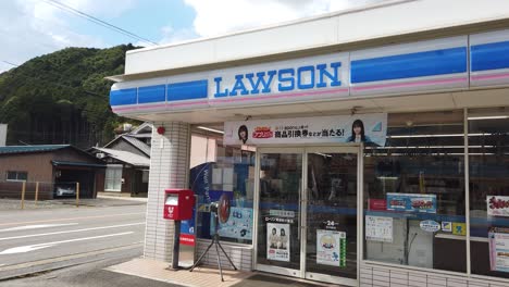 Exterior-of-Convenience-store-Lawson-in-Japan,-static-shot-of-outside-supermarket-in-town-by-road