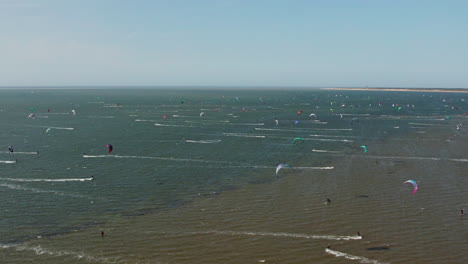 Kite-Surfing-On-The-Scenic-Sea-In-Brouwersdam,-Netherlands---aerial-drone-shot
