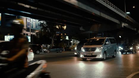 Cars-passing-by-at-nighttime-in-Bangkok,-Thailand-in-slow-motion