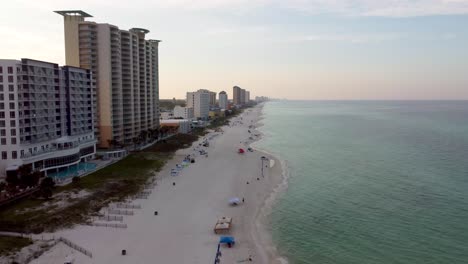 Panama-city-beach-Florida-Aerial-shot-of-beach-and-beachfront-resort-during-morning-dawn-time-with-golden-sky-and-turquoise-water