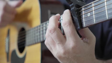 A-guitarist-playing-fingerstyle-on-an-acoustic-guitar