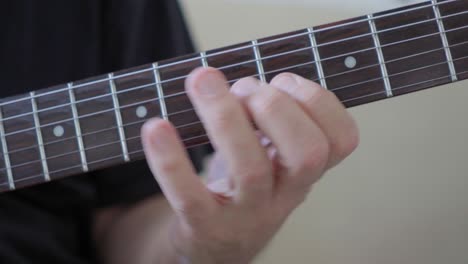 Close-up-of-a-guitarist's-left-hand-improvising-on-an-electric-guitar