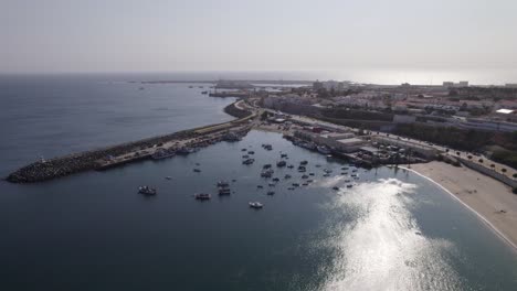 Aerial-Orbiting-shot-of-Sines-fishing-port-by-Vasco-da-Gama-Beach,-Portugal