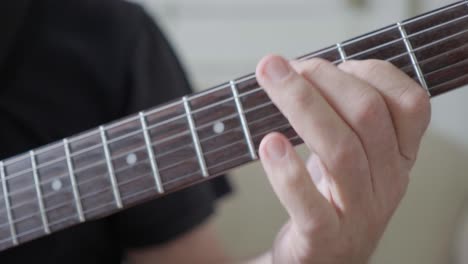 Close-up-of-a-guitarist's-left-hand-improvising-on-an-electric-guitar