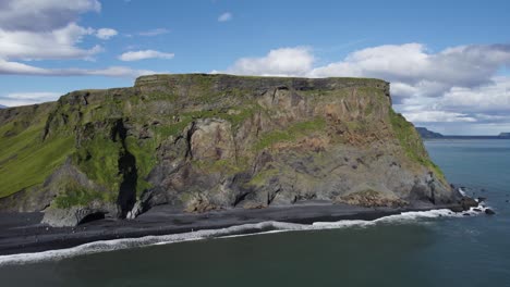 Aerial-Flying-Towards-Beach-Reynisfjara-Cliffs-On-Clear-Day-In-Iceland