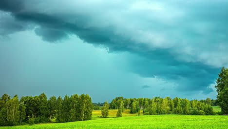 Threatening-thunderstorm-clouds-glide-past-over-a-green-landscape