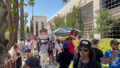 WGA-and-SAG-AFTRA-Strikers-Picketing-Outside-Warner-Brothers-Studios,-near-Gate-2-and-Gate-3,-Under-Tent-on-W-Olive-Ave