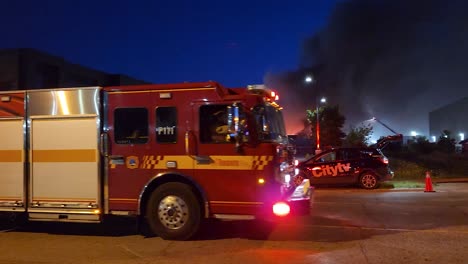 Fire-truck-arriving-at-a-huge-fire-in-the-city-of-Toronto,-Canada