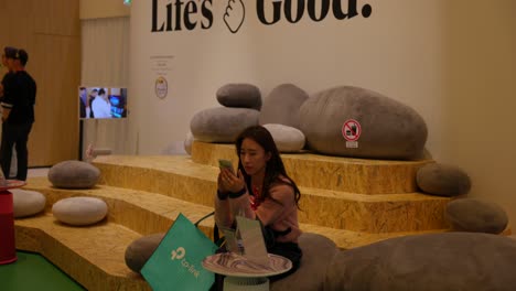 Woman-sit-down-into-Life's-Good-booth-at-IFA-Berlin