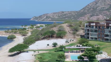 Scenic-aerial-forward-over-swimming-pool-in-tropical-hotel-resort-Puntarena