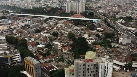Aerial-top-down-shot-of-Slum-District-of-Jakarta-City-and-traffic-on-highway