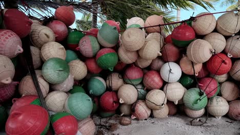 A Huge Pile Of Colourful Plastic Fishing Buoys Stacked Up Under