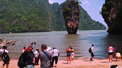 Tourists-visiting-Phang-Nga-bay-beach-on-James-Bond-island-in-Thailand